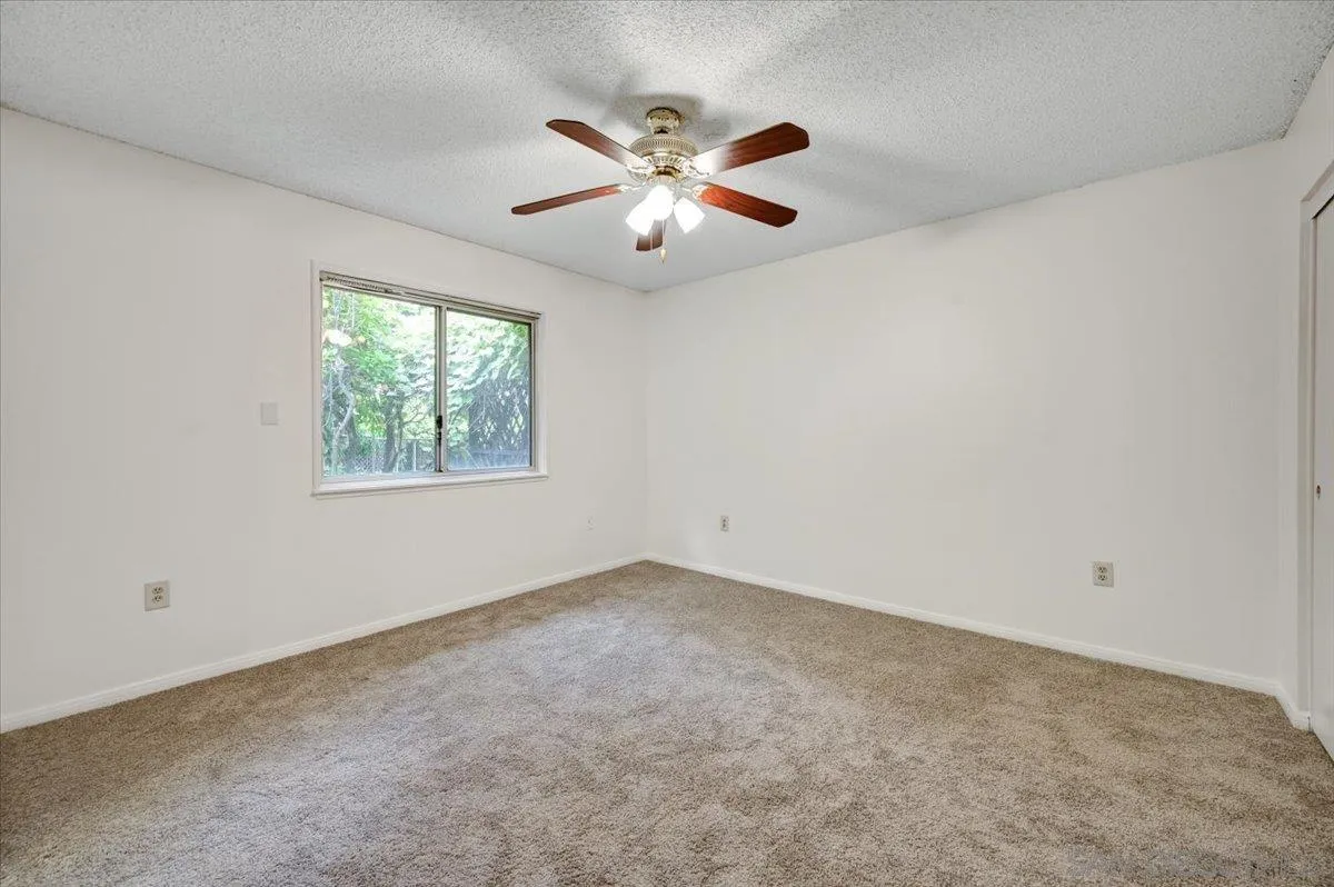 27335 Ventan Street Menifee, CA 92586 - Photo 20 of 36 an empty room with windows and fan