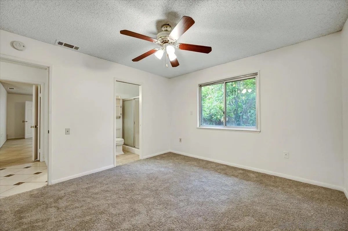 27335 Ventan Street Menifee, CA 92586 - Photo 21 of 36 an empty room with ceiling fan and window