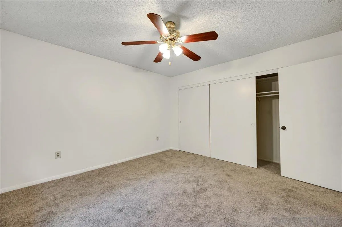 27335 Ventan Street Menifee, CA 92586 - Photo 22 of 36 an empty room with closet and ceiling fan