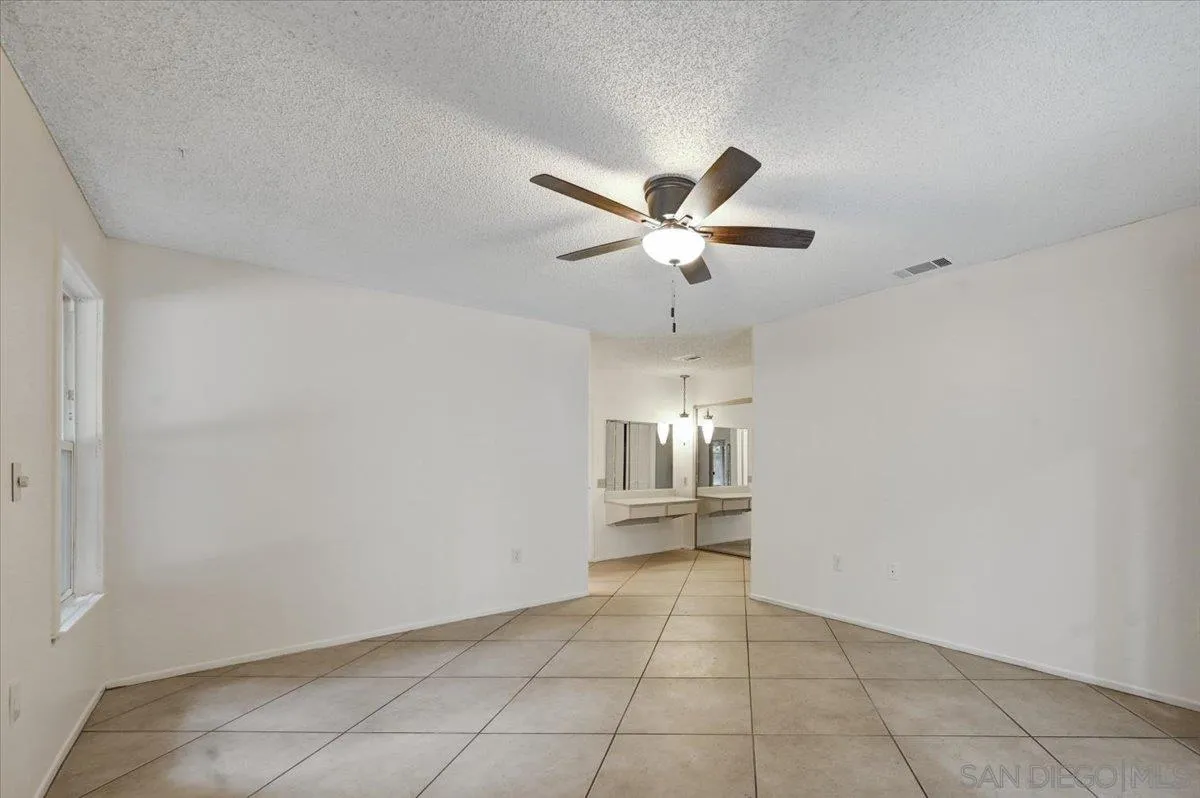 27335 Ventan Street Menifee, CA 92586 - Photo 25 of 36 an empty room with a view of a kitchen