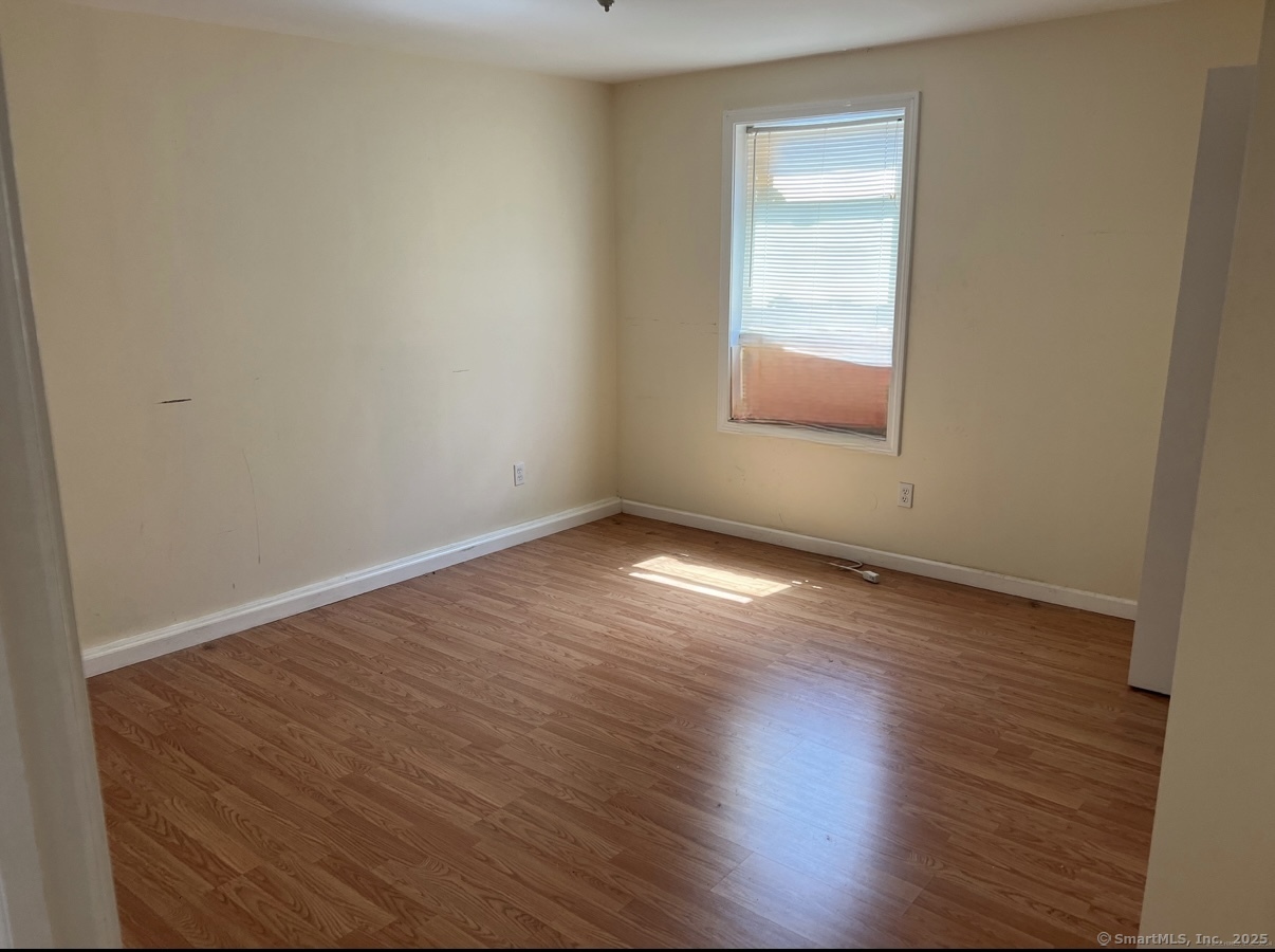 539 Howe Avenue, Unit 2B Shelton, CT 06484 - Photo 6 of 10 an empty room with wooden floor and windows
