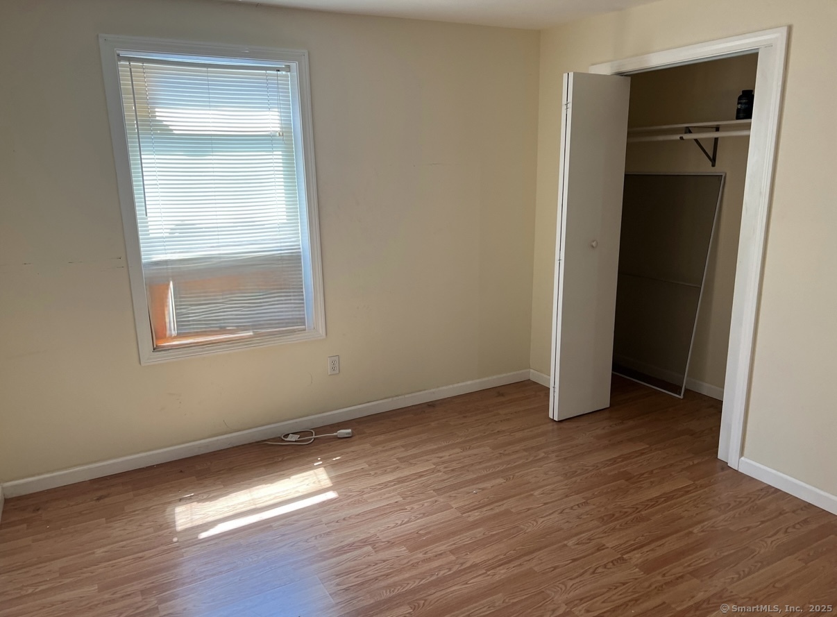539 Howe Avenue, Unit 2B Shelton, CT 06484 - Photo 7 of 10 an empty room with wooden floor and closet