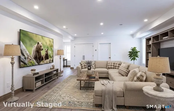 a living room with furniture and a flat screen tv