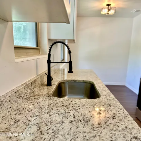 a kitchen with a sink a vanity and a window