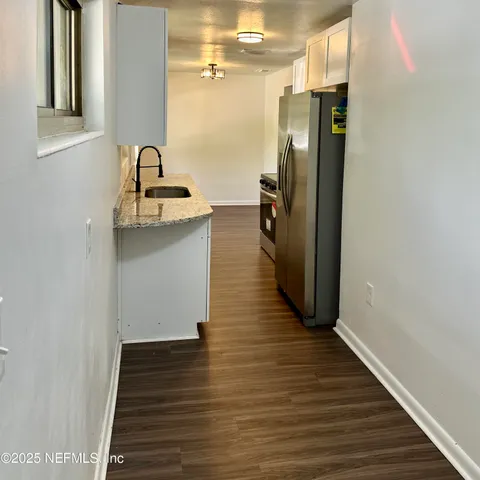 a kitchen with sink and refrigerator