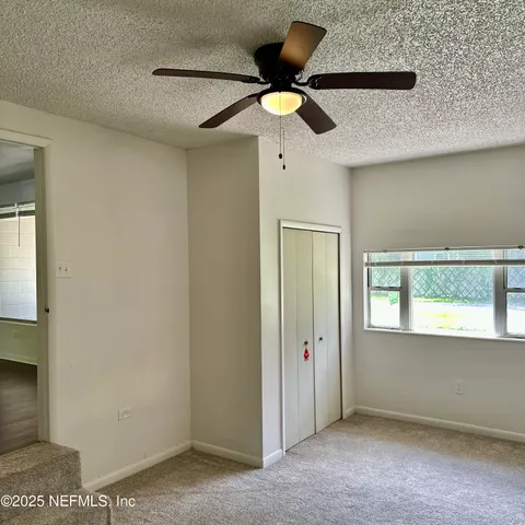 a view of an empty room with a window