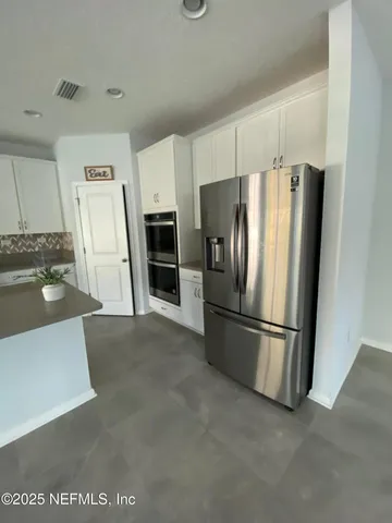 a kitchen with stainless steel appliances a refrigerator and a stove