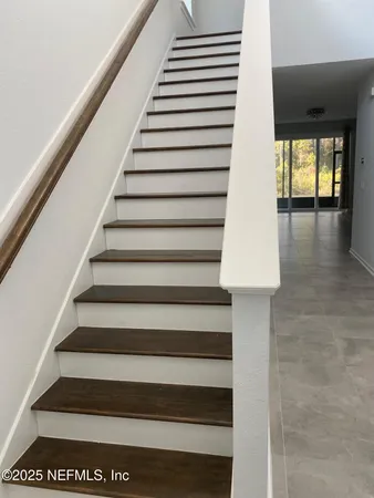 a view of entryway and hall with wooden floor