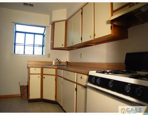 114 Redbud Road, Unit 114 Piscataway, NJ 08854 - Photo 4 of 7 a kitchen with stainless steel appliances granite countertop a sink and a stove