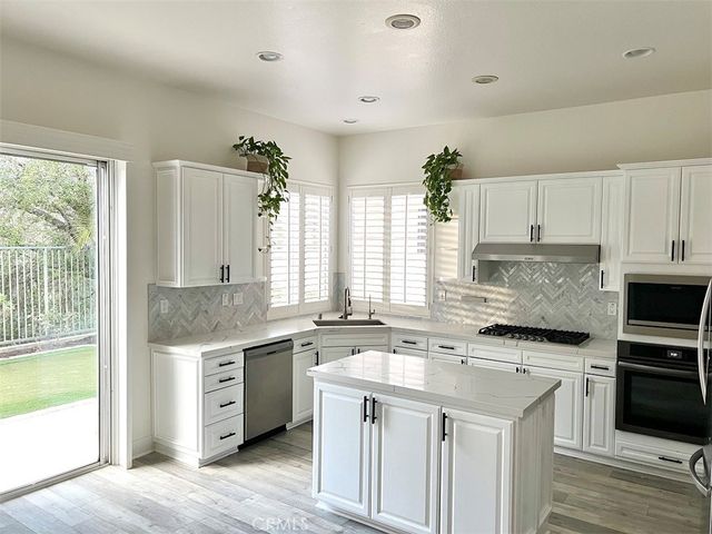 a kitchen with a sink stove and cabinets