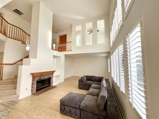 a living room with furniture a fireplace and a large window