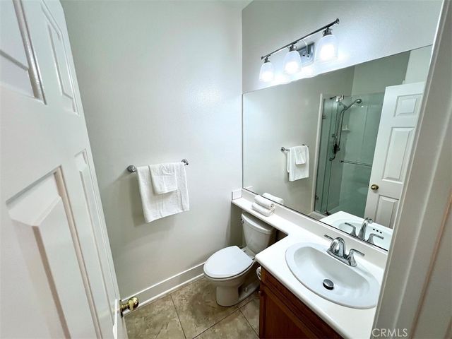 a bathroom with a sink a toilet and shower a mirror