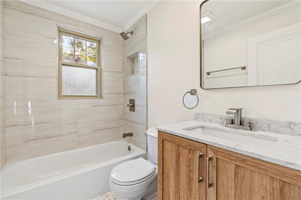 100 Race Street Pittsburgh, PA 15218 - Photo 12 of 25 a bathroom with a granite countertop sink a toilet and a bathtub