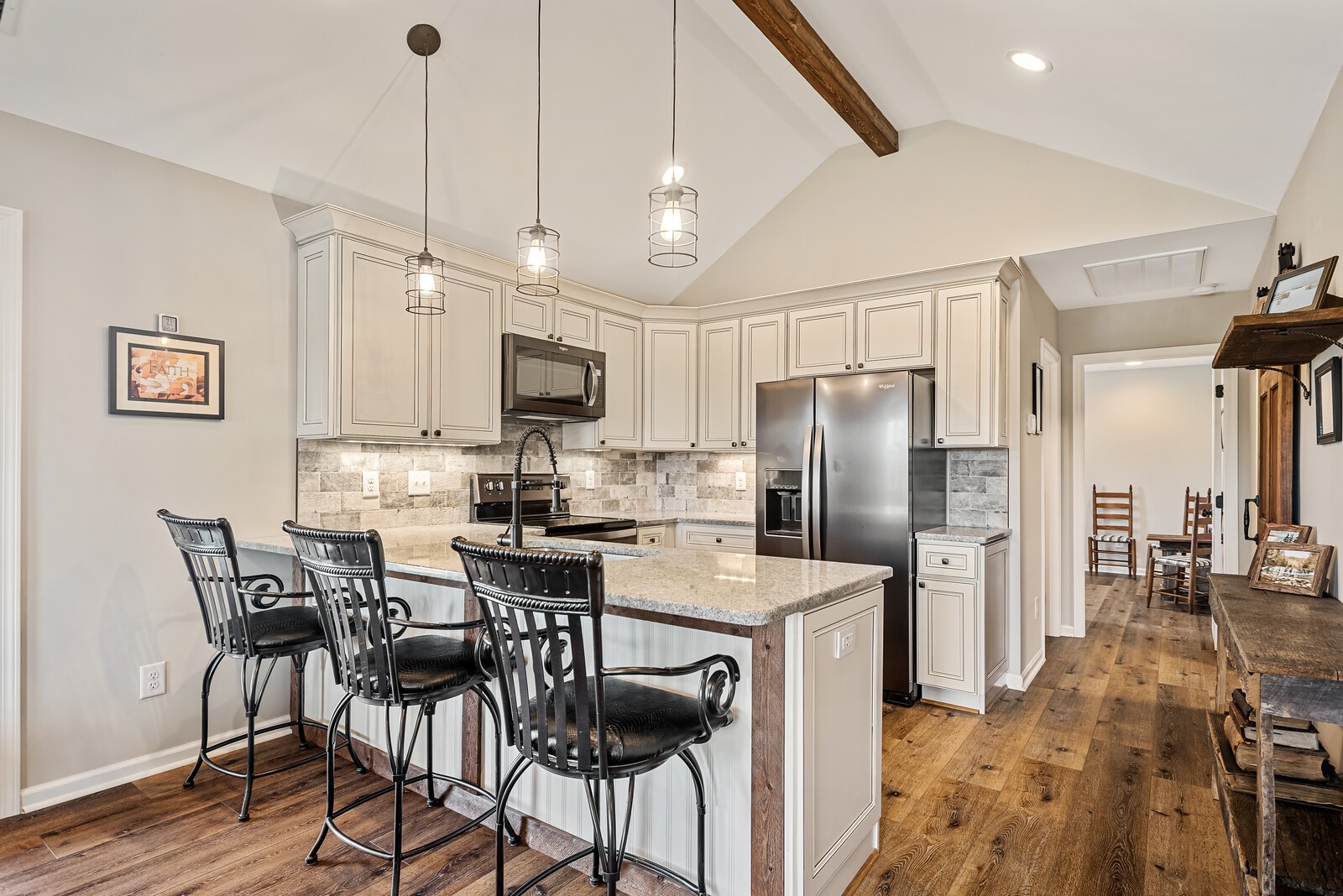 791 Coon Branch Road Alexandria, TN 37012 - Photo 10 of 33 a kitchen with stainless steel appliances kitchen island granite countertop a dining table chairs and white cabinets
