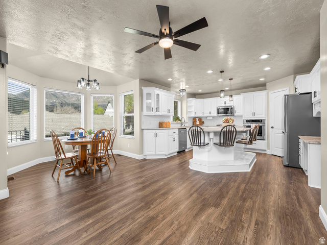 6849 North Black Powder Road Mountain Green, UT 84050 - Photo 6 of 43 Open-concept living space featuring wood-finish flooring, a contemporary ceiling fan, and recessed lighting