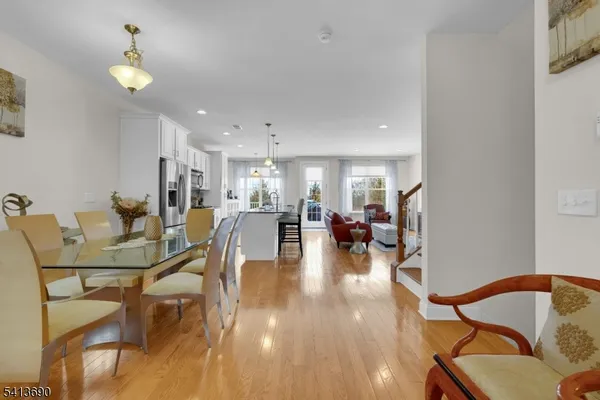 a living room with furniture a flat screen tv and kitchen area