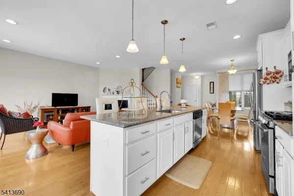 a bedroom with a large bed and a potted plant