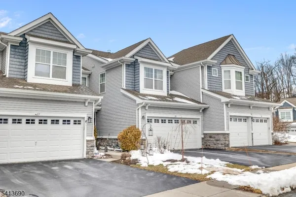 a living room with a balcony a bed and a dresser