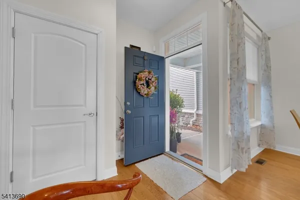 a living room with furniture and a view of kitchen