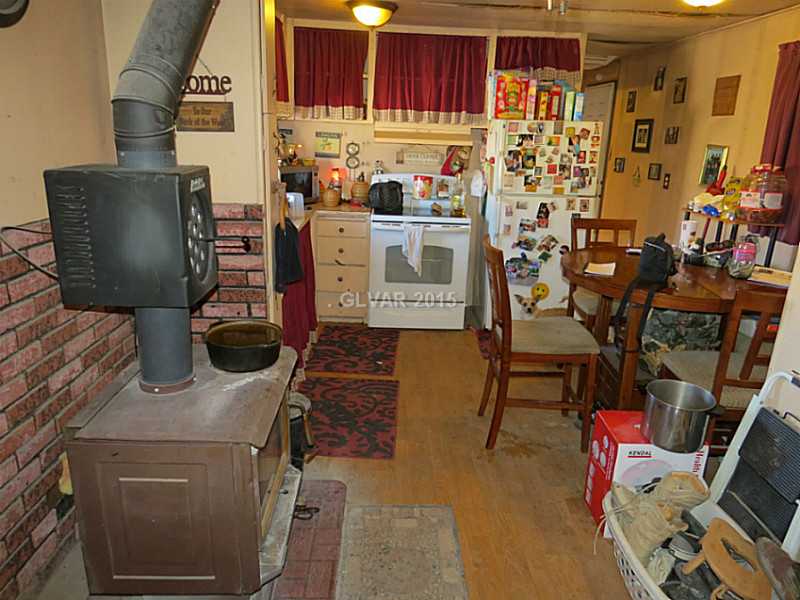 17 Mahogany Street Ruth, NV 89319 - Photo 5 of 13 Kitchen. Kitchen with breakfast nook, and a view of the living room wood burning stove.
