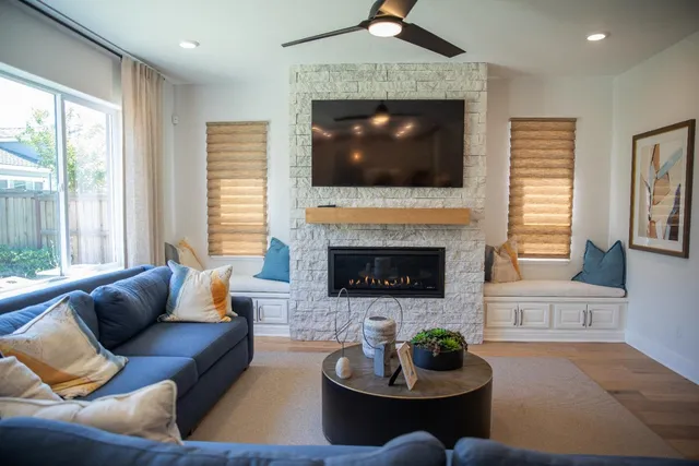 a living room with furniture fireplace and window