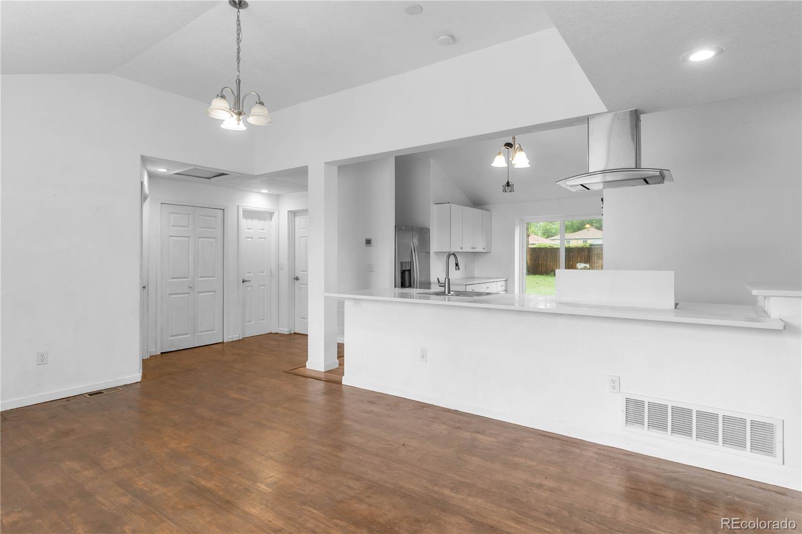 7010 West 44th Avenue Wheat Ridge, CO 80033 - Photo 4 of 31 a view of a kitchen with a sink and chandelier
