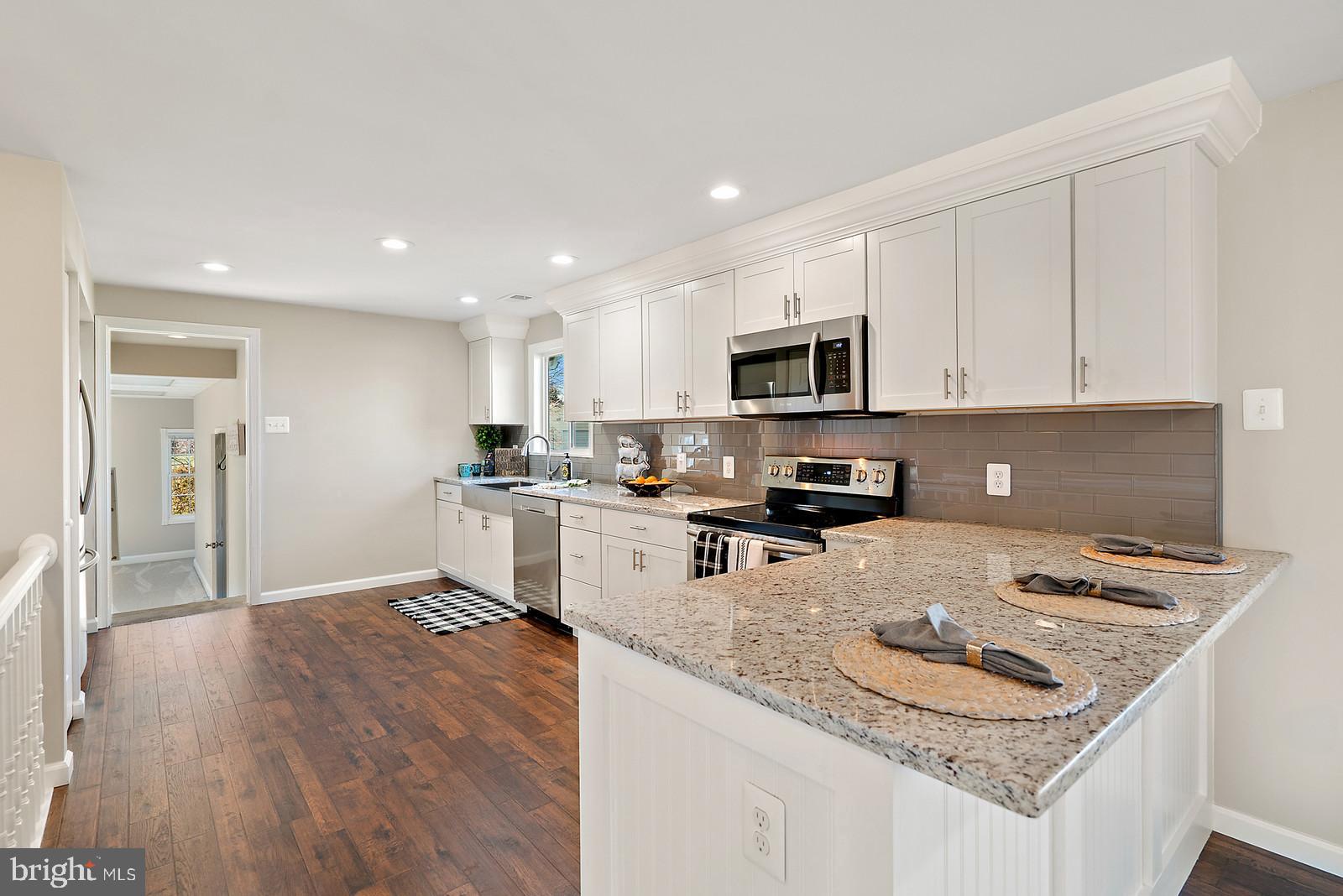 2695 Logmill Road Haymarket, VA 20169 - Photo 9 of 42 Classic white kitchen w/ granite & tile backsplash