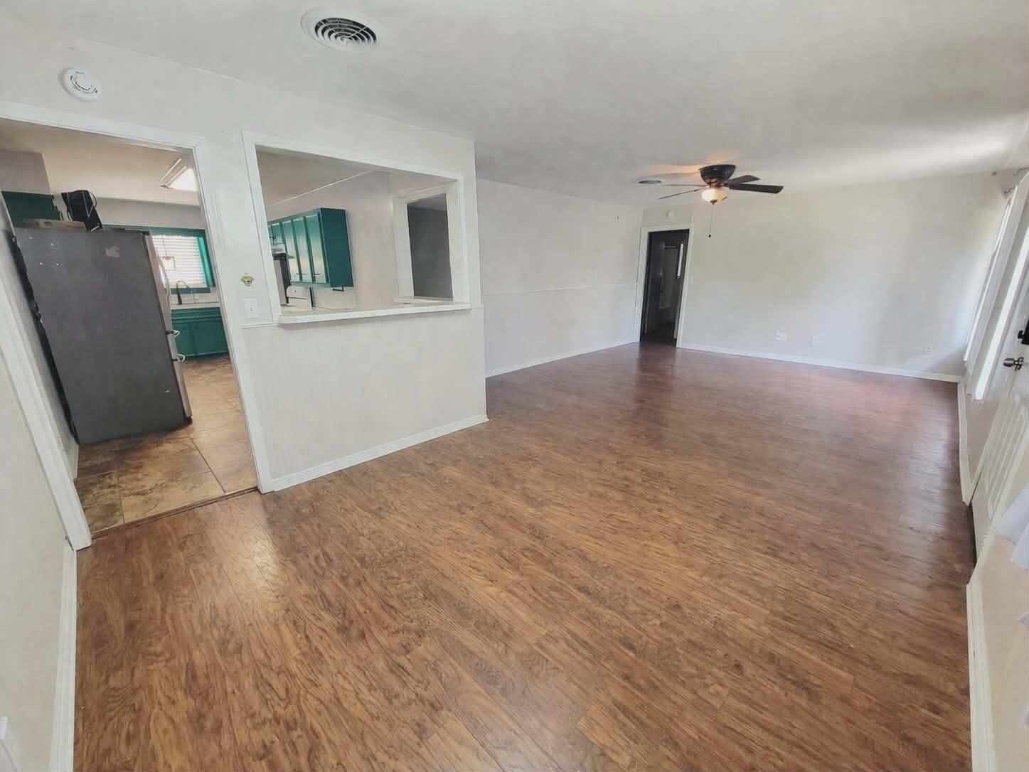 3408 38th Street Lubbock, TX 79413 - Photo 4 of 18 a view of a livingroom with wooden floor and a ceiling fan