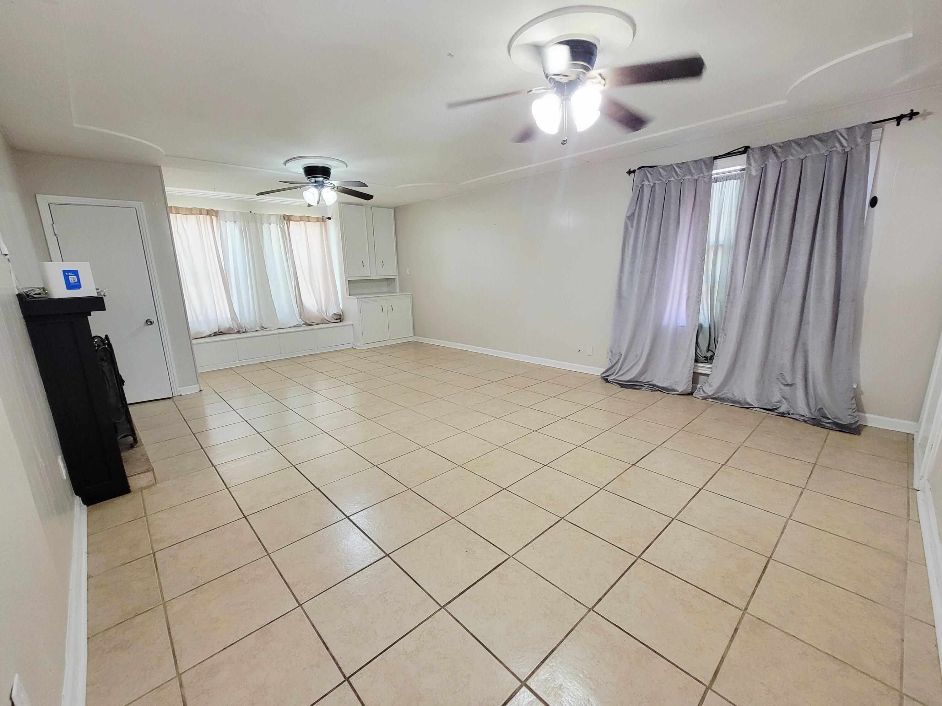 3408 38th Street Lubbock, TX 79413 - Photo 10 of 18 a view of entryway with stairs and a chandelier fan