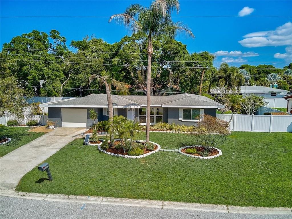 a view of a house with backyard sitting area and garden