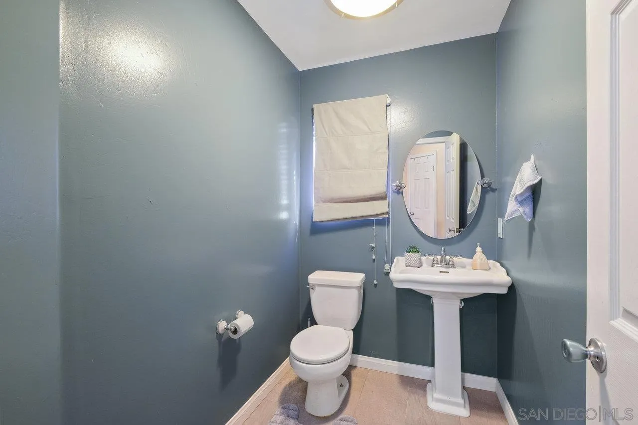 863 Rydell Place El Cajon, CA 92021 - Photo 13 of 23 a bathroom with a toilet sink a mirror and vanity