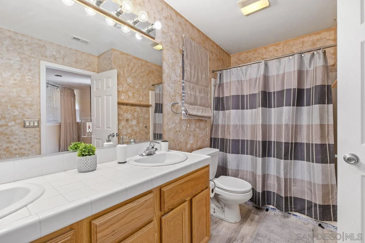 863 Rydell Place El Cajon, CA 92021 - Photo 18 of 23 a bathroom with a double vanity sink toilet and shower