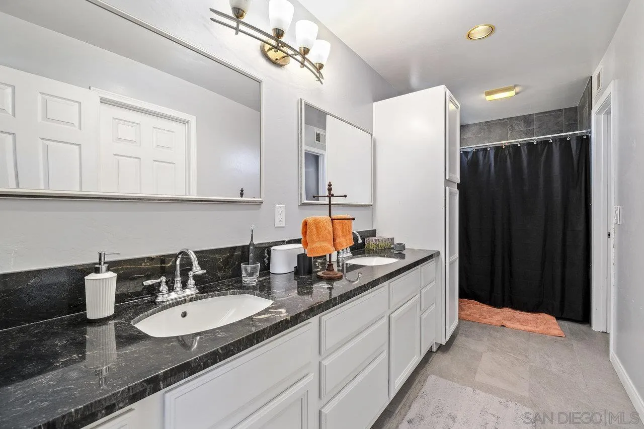 863 Rydell Place El Cajon, CA 92021 - Photo 21 of 23 a bathroom with double sink and a mirror