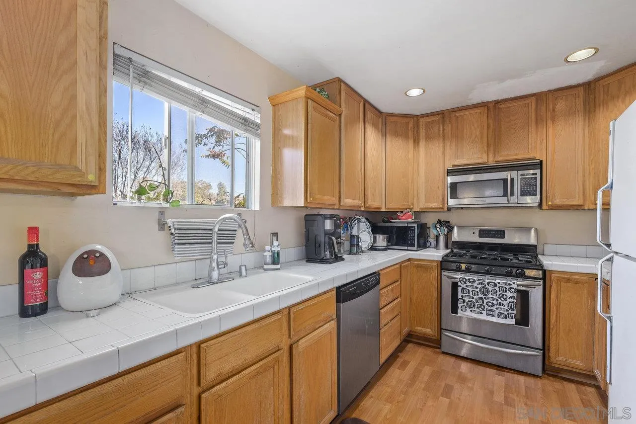 863 Rydell Place El Cajon, CA 92021 - Photo 10 of 23 a kitchen with stainless steel appliances granite countertop a sink stove and cabinets