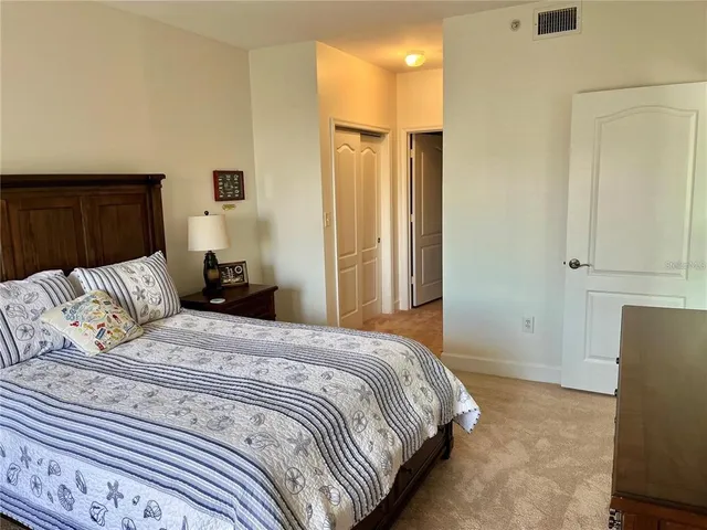 a bedroom with a large bed and a dresser