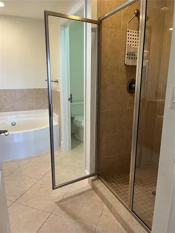 a bathroom with a shower and a glass door