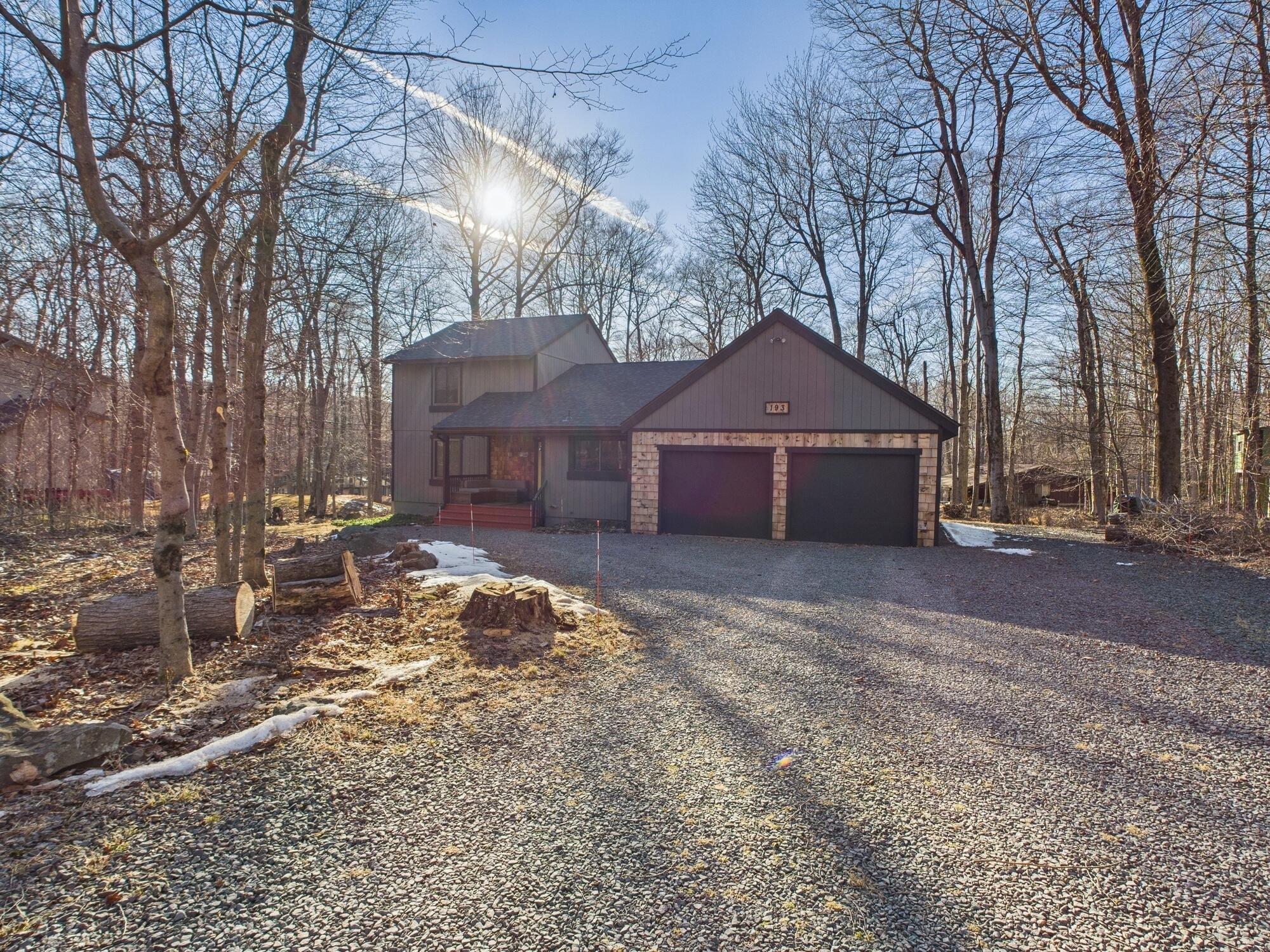 193 Elk Run Road Pocono Lake, PA 18347 - Photo 1 of 51 a front view of a house with a yard and garage