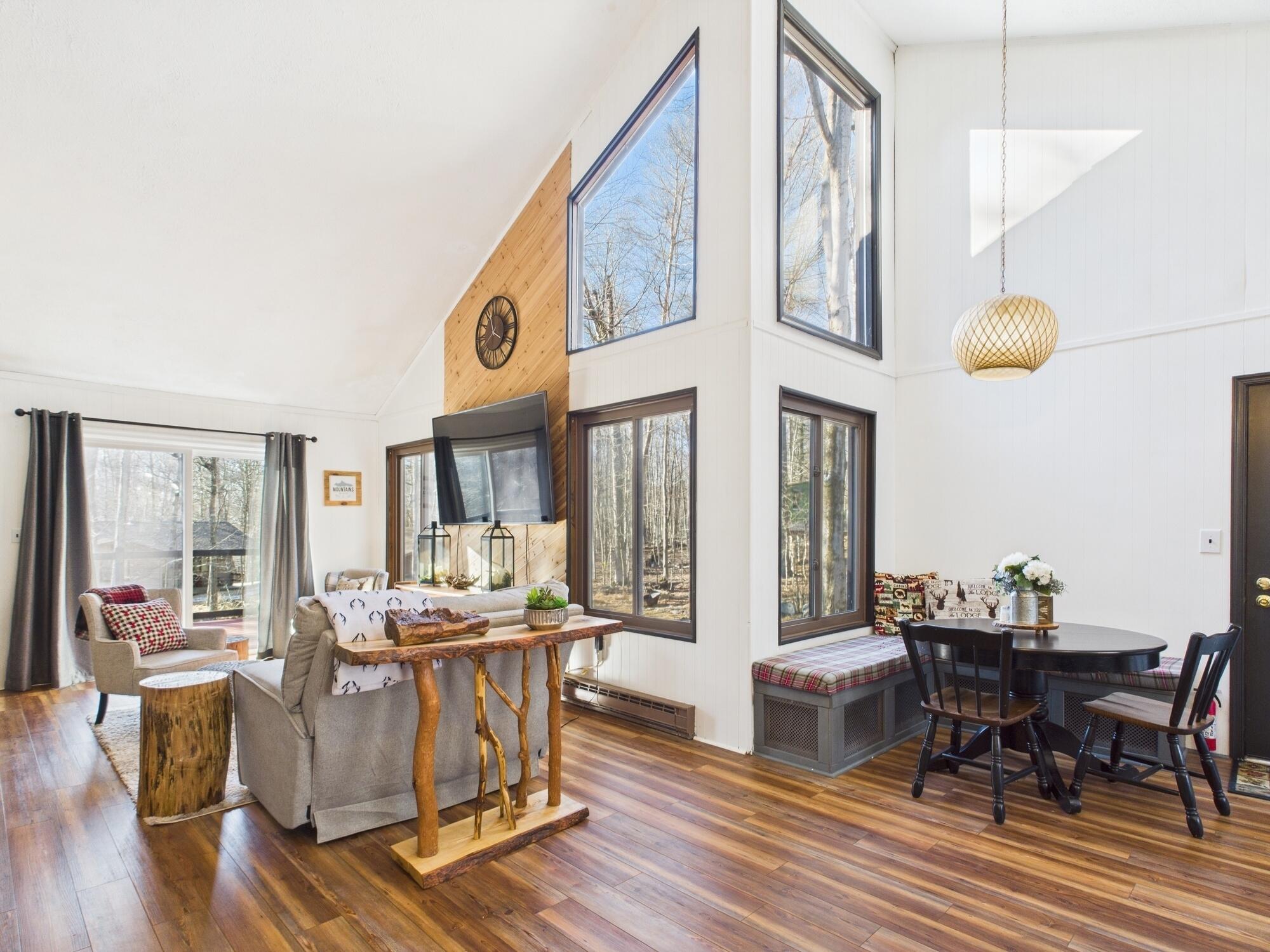 193 Elk Run Road Pocono Lake, PA 18347 - Photo 13 of 51 a living room with fireplace furniture dining table and a large window