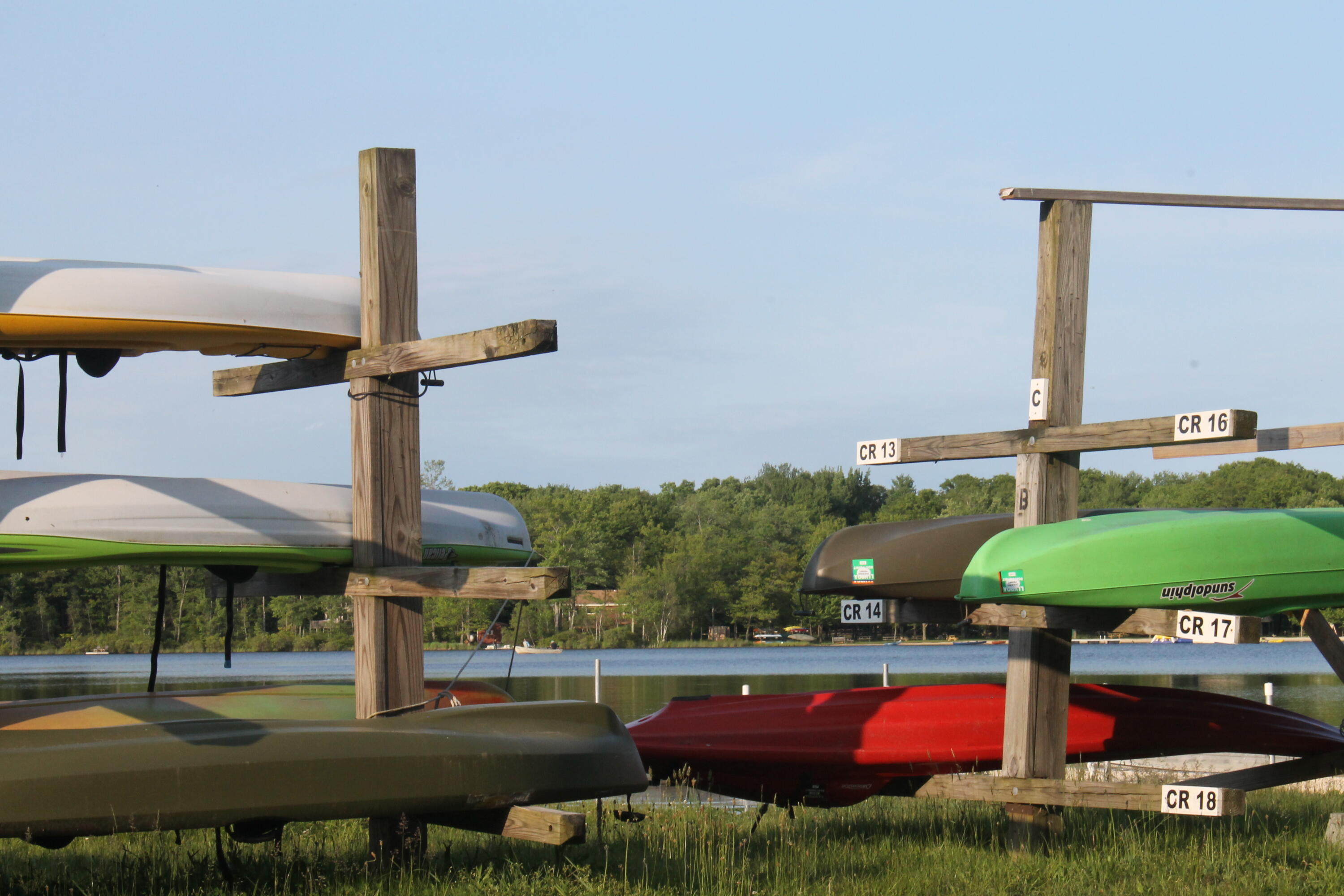 193 Elk Run Road Pocono Lake, PA 18347 - Photo 49 of 51 a roof deck with table and chairs under an umbrella with a fire pit