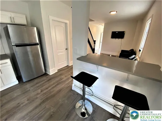 a living room with furniture and a mirror