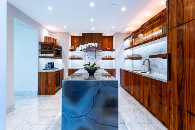 a kitchen with stainless steel appliances granite countertop a refrigerator and a sink