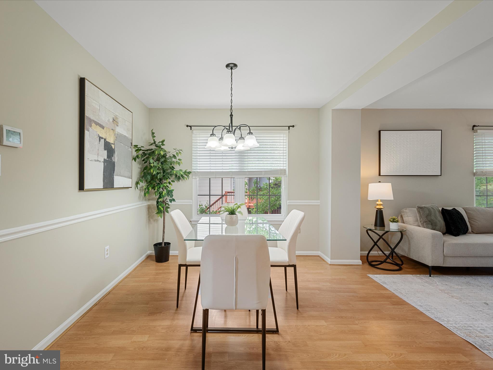 20760 Apollo Terrace Ashburn, VA 20147 - Photo 11 of 50 a view of a dining room with furniture window and wooden floor