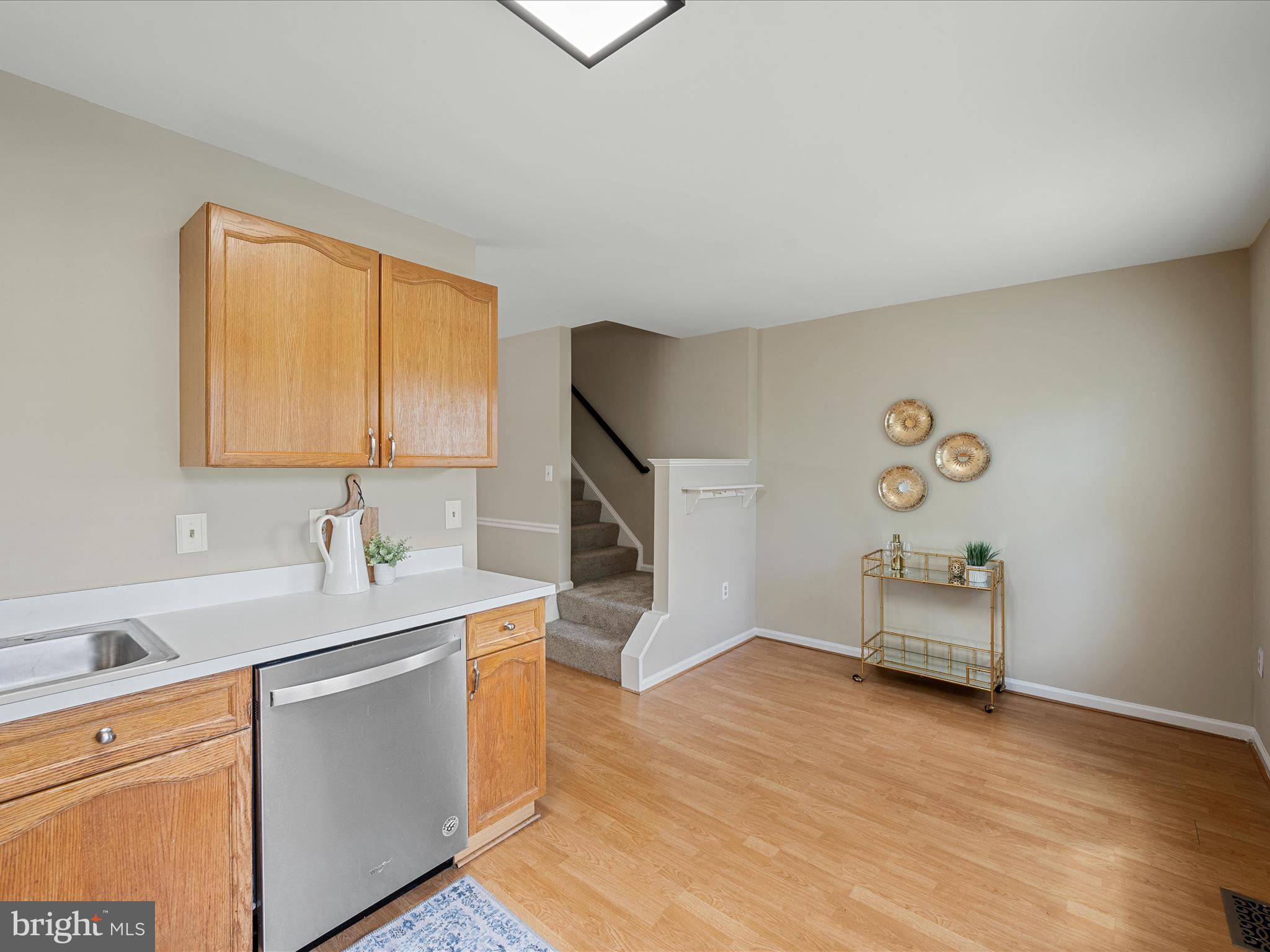 20760 Apollo Terrace Ashburn, VA 20147 - Photo 19 of 50 a kitchen with a sink cabinets and a wooden floor