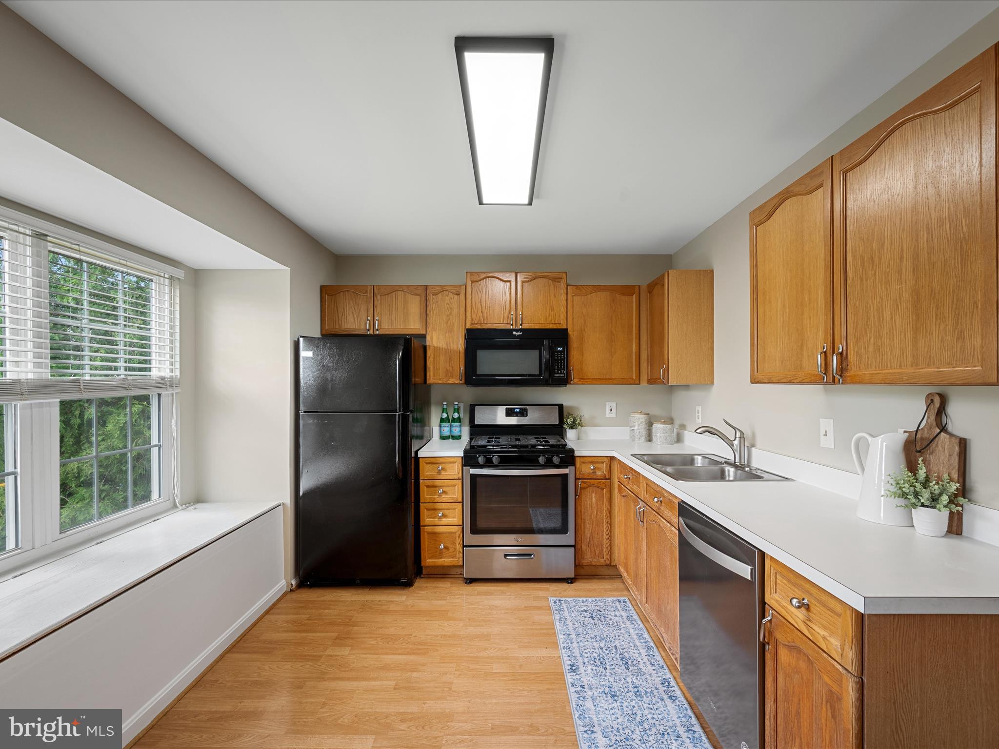 20760 Apollo Terrace Ashburn, VA 20147 - Photo 21 of 50 a kitchen with a sink wooden cabinets and stainless steel appliances