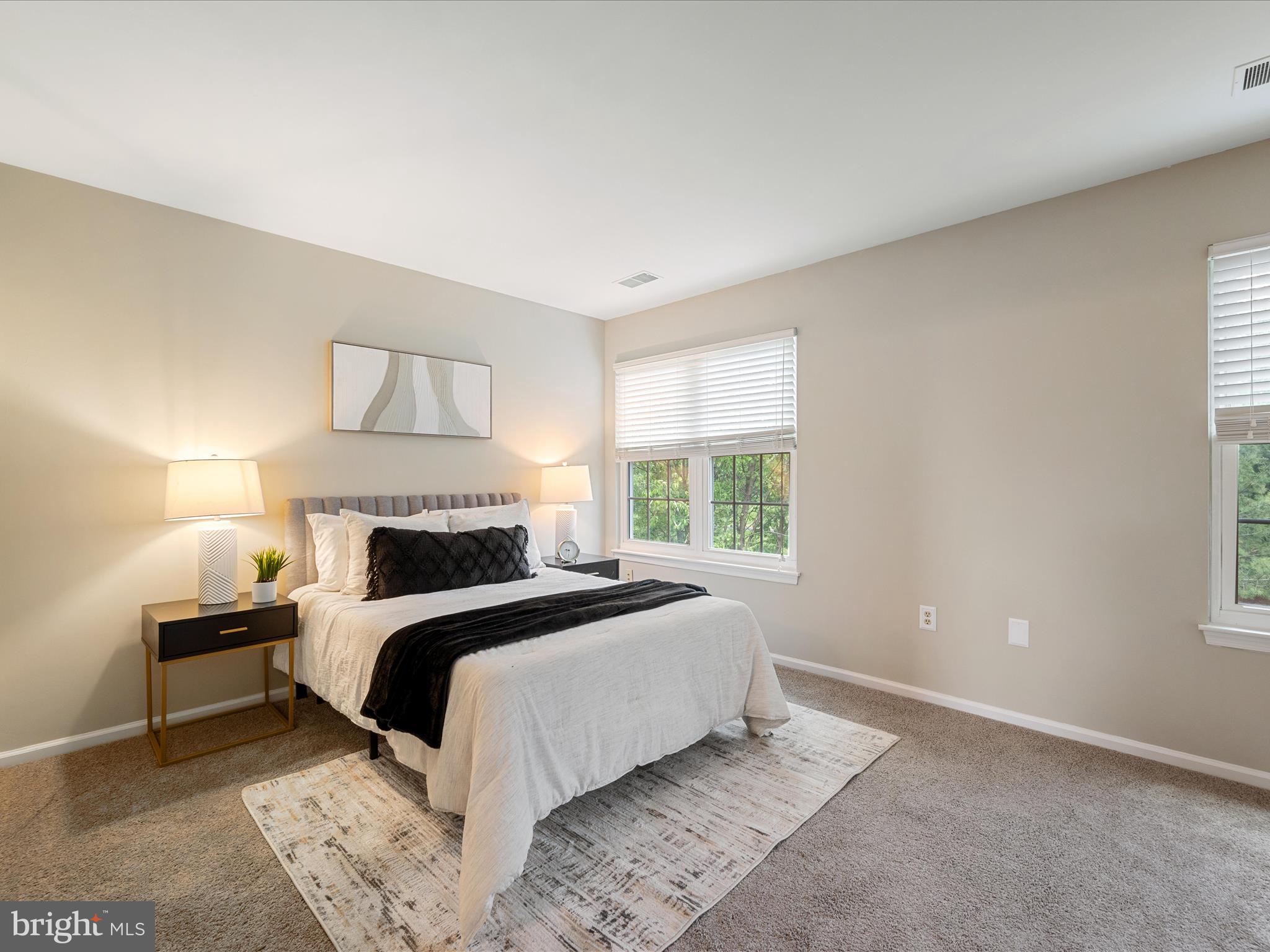 20760 Apollo Terrace Ashburn, VA 20147 - Photo 22 of 50 a bed room with a bed and a lamp