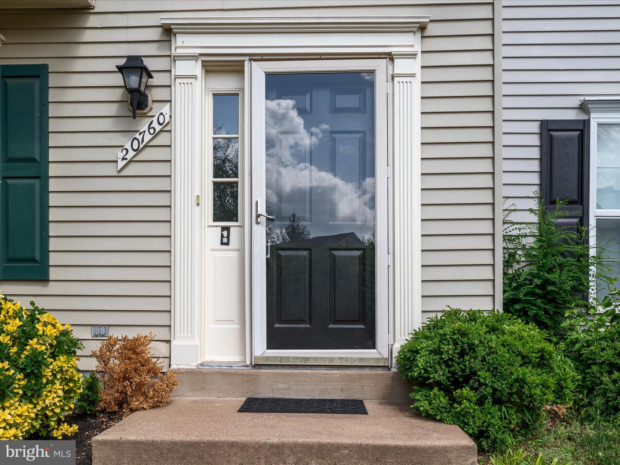 20760 Apollo Terrace Ashburn, VA 20147 - Photo 32 of 50 a front view of a house with a garden