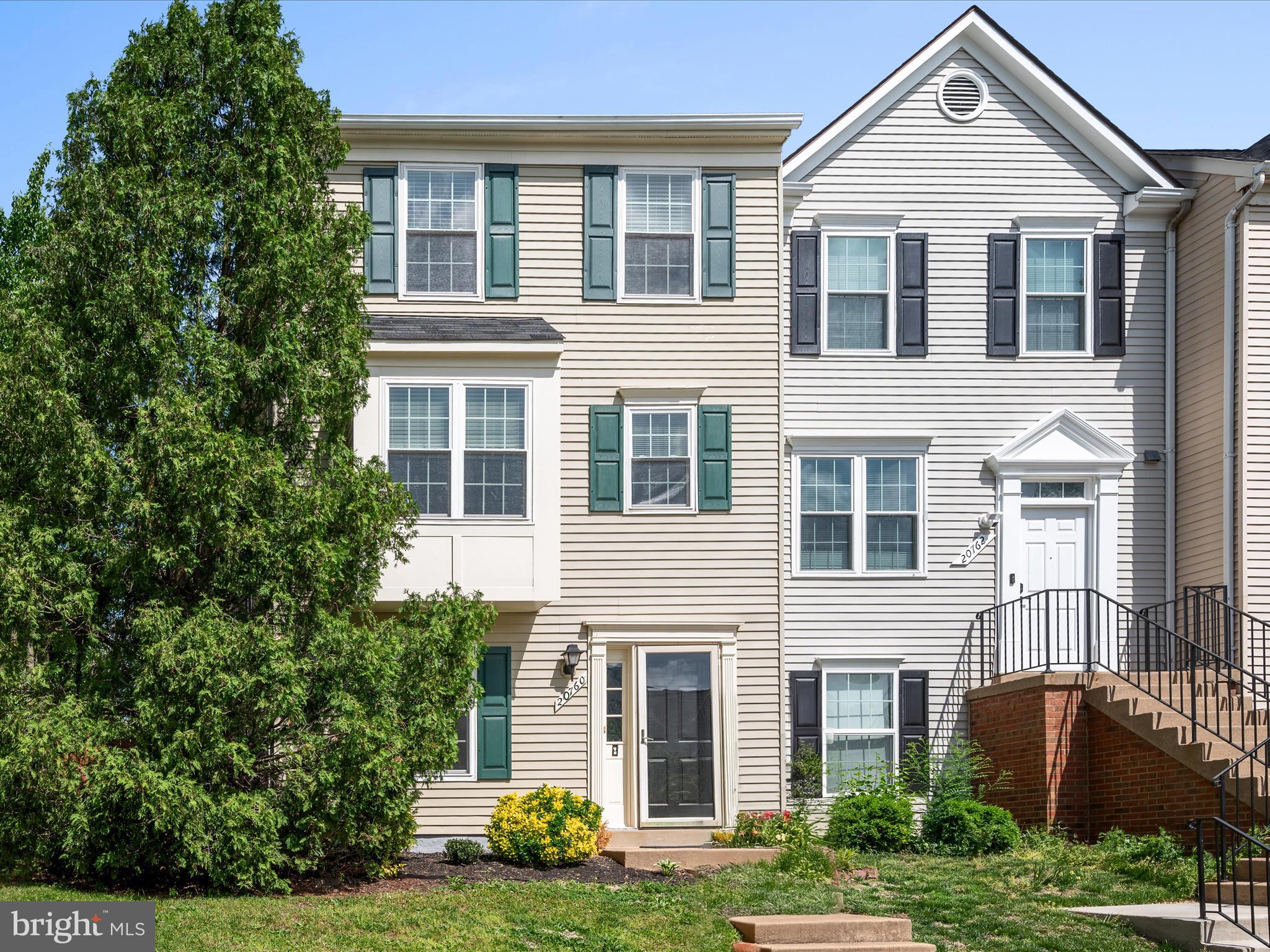 20760 Apollo Terrace Ashburn, VA 20147 - Photo 34 of 50 a front view of a house with a yard and garage