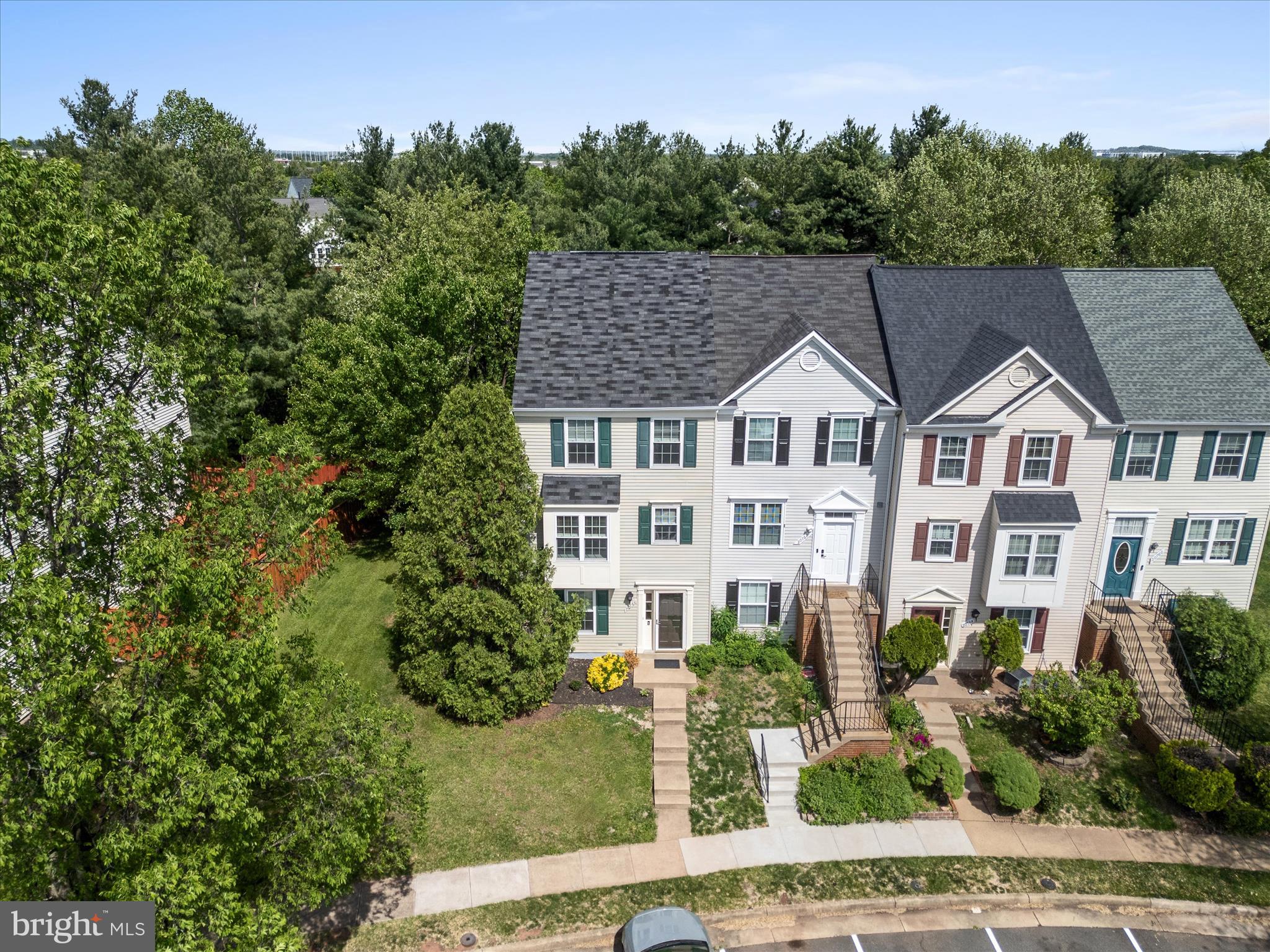 20760 Apollo Terrace Ashburn, VA 20147 - Photo 36 of 50 a view of a white house next to a yard with potted plants