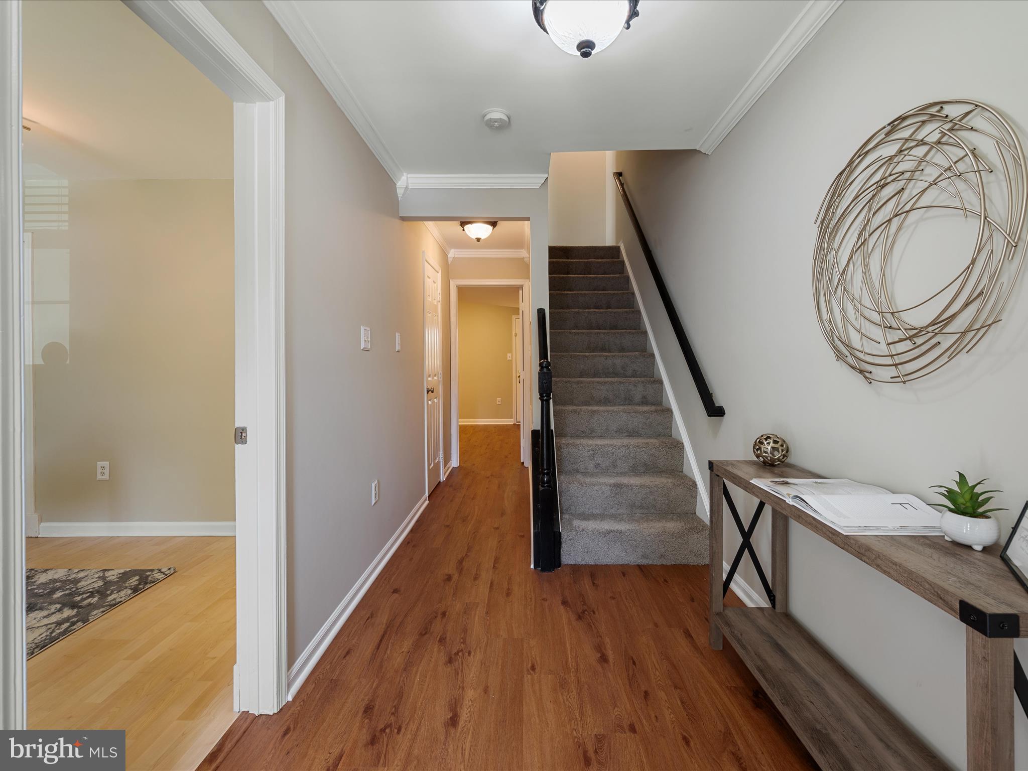 20760 Apollo Terrace Ashburn, VA 20147 - Photo 4 of 50 a view of a hallway with wooden floor and staircase
