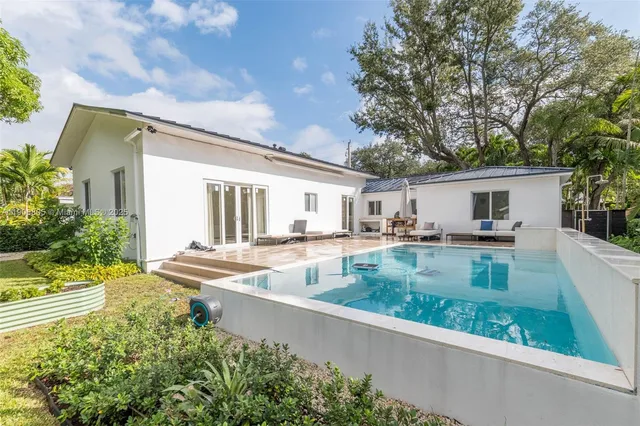 a view of house with swimming pool and chair